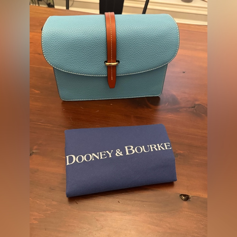 Dooney and Bourke Pebble grain leather Flap crossbody/shoulder bag in sky blue.